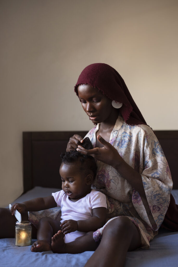 A woman styling the hair of a small child