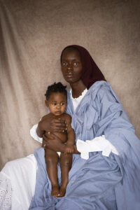 A woman seated with child