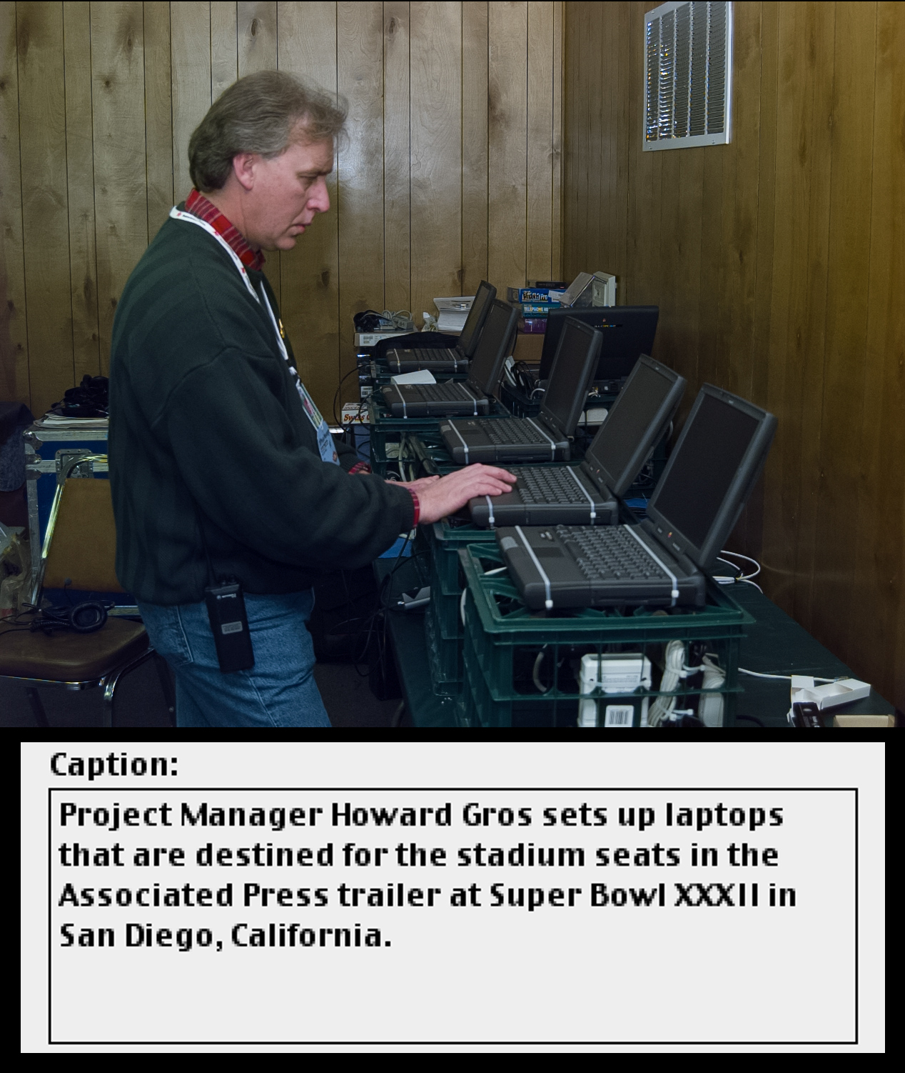 A man works at a vintage computer laptop