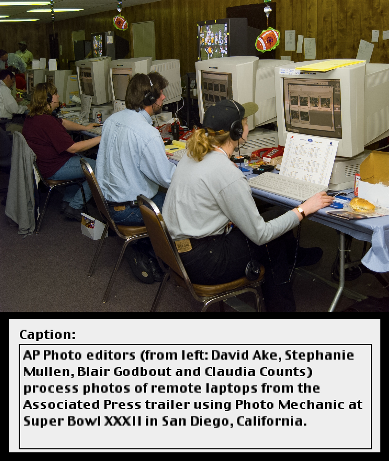 Four editors sit in front of computer workstations