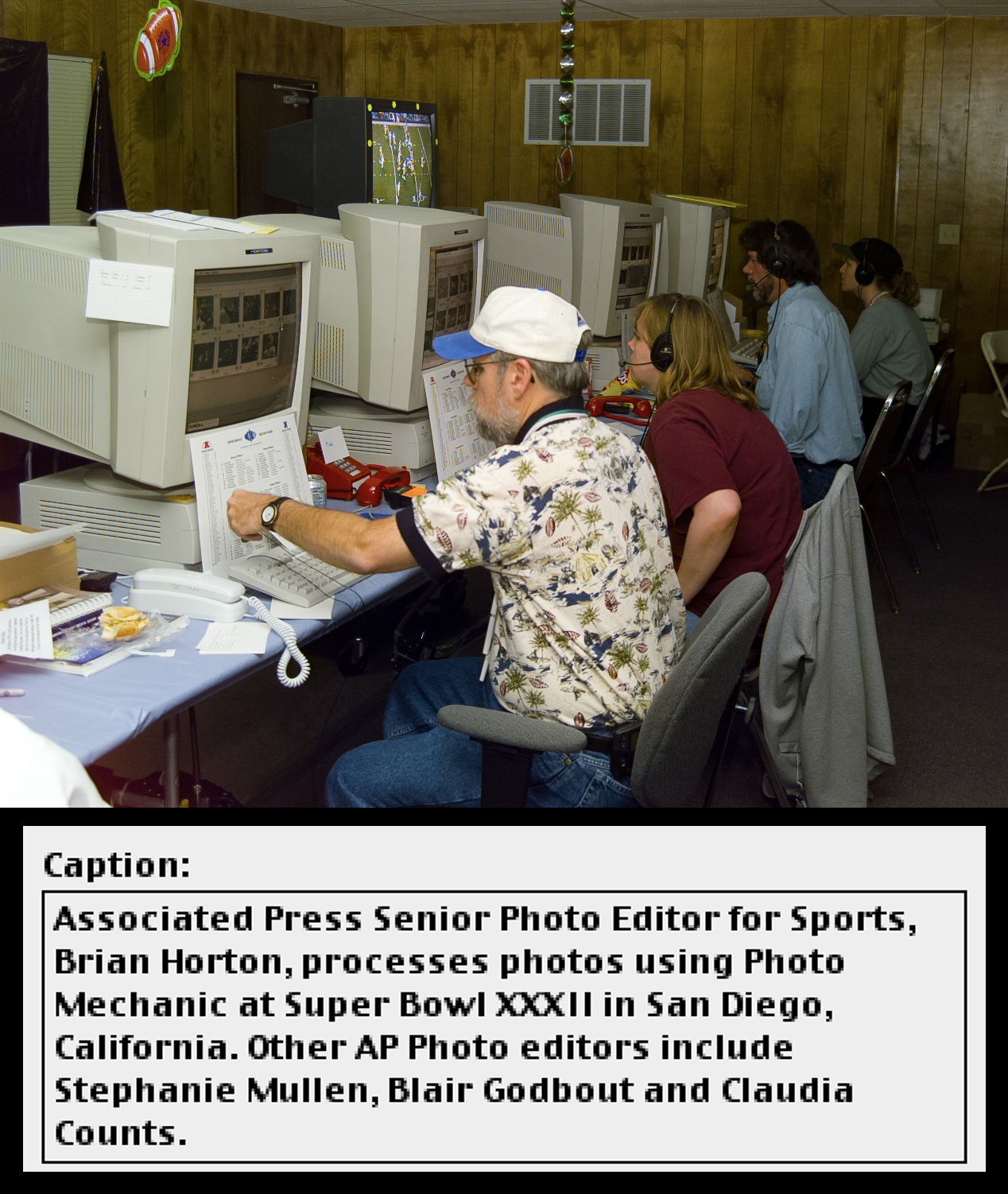 Four editors sit in front of computer workstations